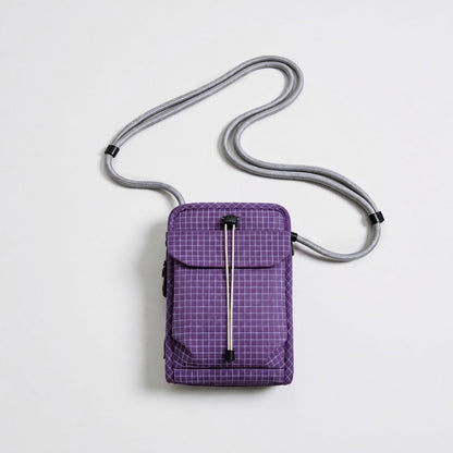 Front view of the vibrant purple grid magnetic utility pouch with water-resistant ripstop nylon.