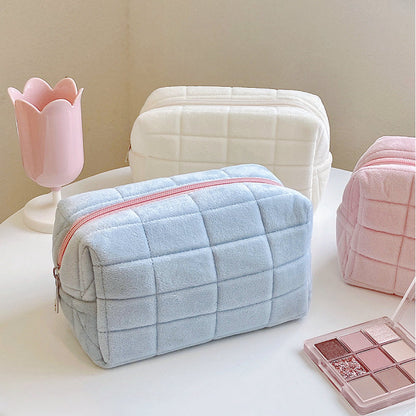 Close-up of Icecream Makeup Bag in blue, easy to pack for trips and daily use.