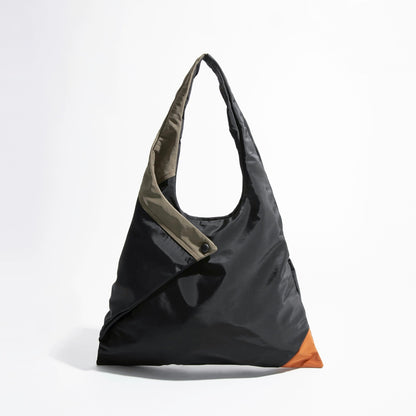 Front view of the Jungle Triangle Tote bag showing the black nylon exterior and olive green handle detail.
