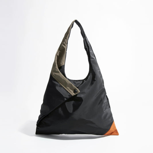Front view of the Jungle Triangle Tote bag showing the black nylon exterior and olive green handle detail.