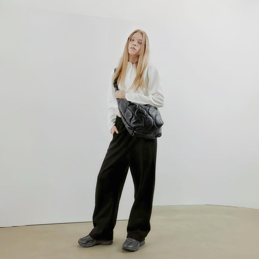 Model carrying a Large Quilted Slouchy Bag as crossbody in black, easy for commuting and weekends.