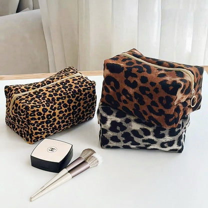 Angled view of three Leopard Allure Makeup Bags, great for on-the-go touch-ups.