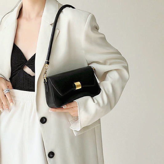 Model carrying a Light Leather Arc Baguette Shoulder Bag, great for daily carry and travel.