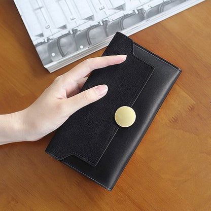 Model holding Long Wallet With Nubuck Leather Flap in black, great for daily carry and travel.