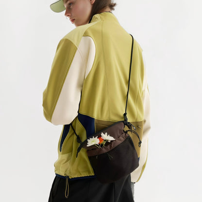 Model carrying a brown nylon  bag as crossbody, easy for commuting and weekends.
