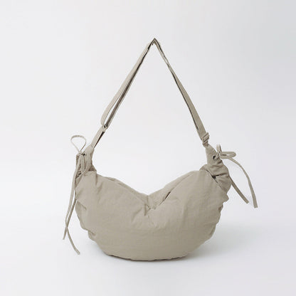 Front view of the khaki mini duvet crescent bag showing the adjustable drawstring and ruched texture.