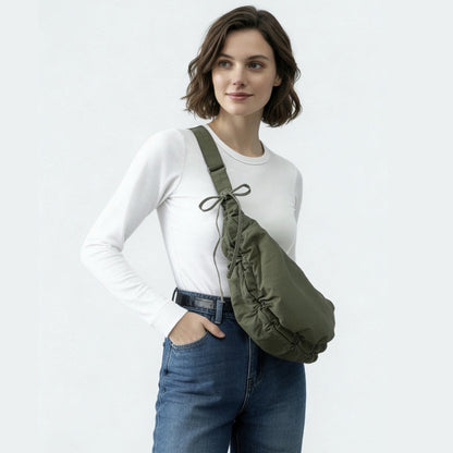 Model wearing the olive green version of the duvet crescent bag as crossbody.