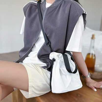 Model wearing the off-white mini nylon bag as a crossbody.