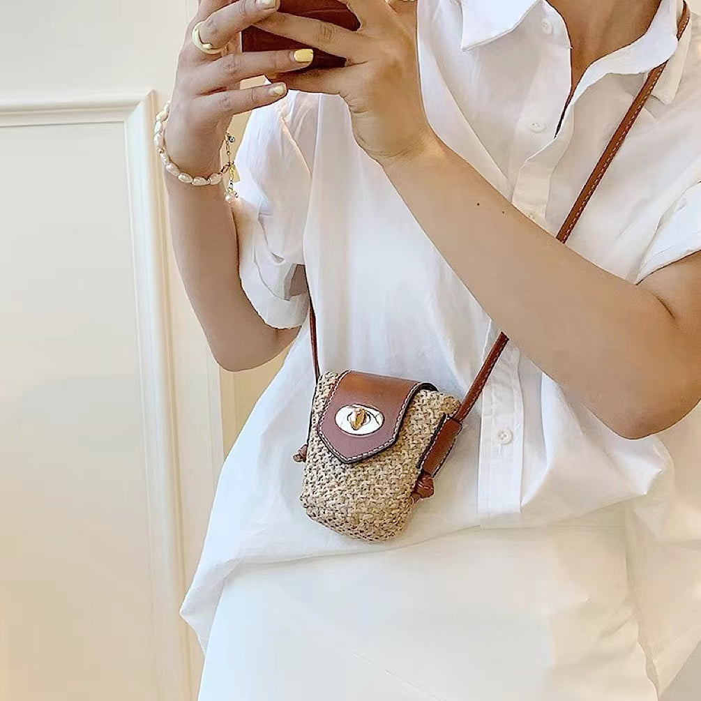 Model wearing a small size of Raffia Straw Bucket Crossbody Bag, ideal for errands and gifting.