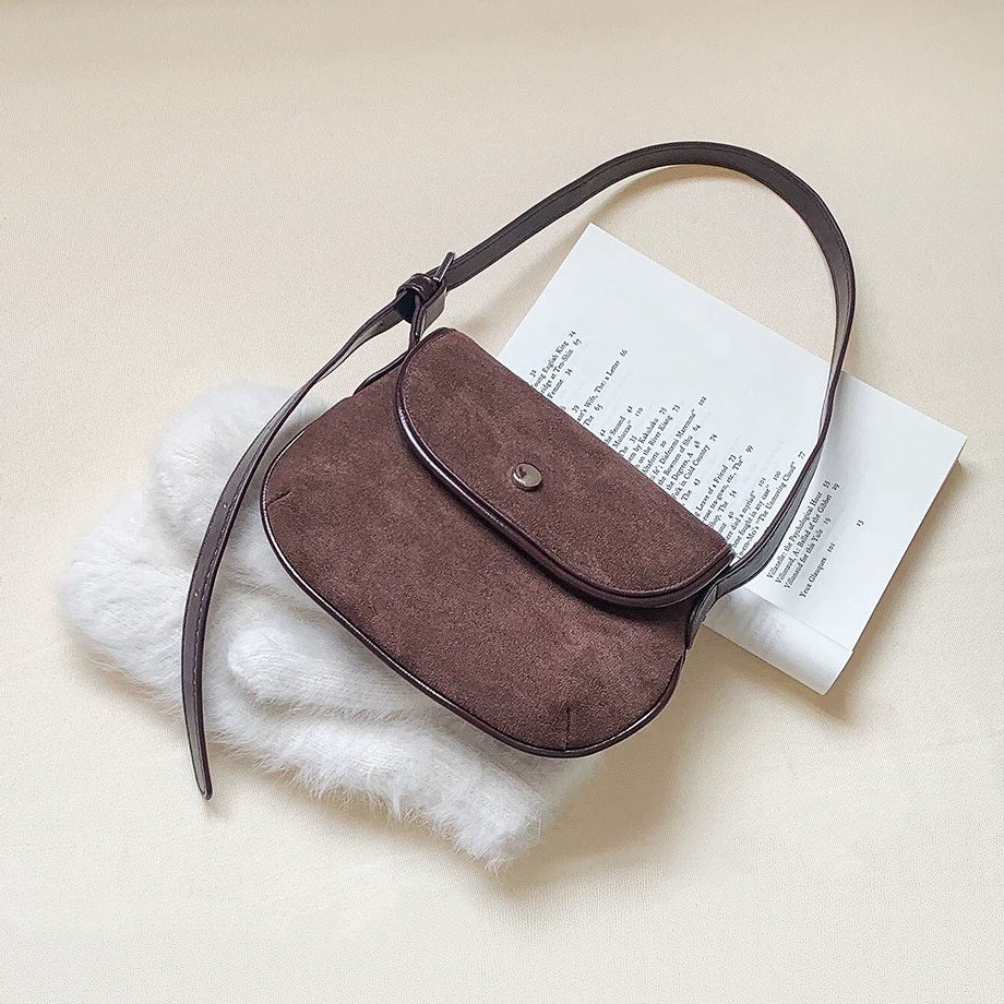 Solid brown color version of the mini suede saddle bag with clean-cut edges.