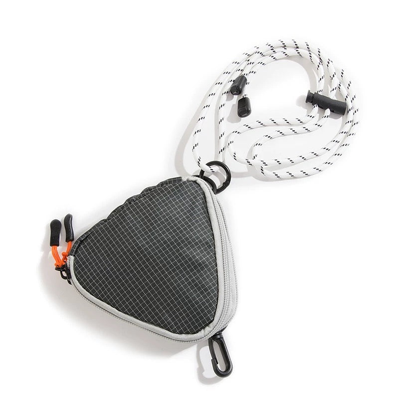 A black triangle mini bag made of durable nylon, featuring a zip-top and adjustable strap.