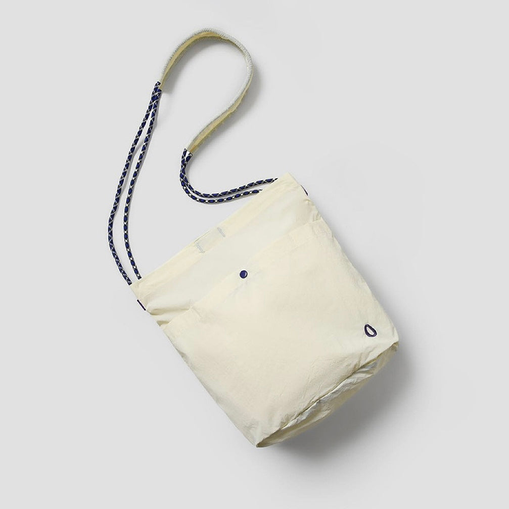 An off-white casual bag with a minimalist aesthetic, suitable for both campus and office.