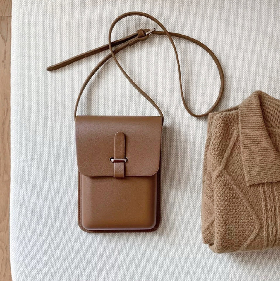 Flat lay of Minimalist Rigid Leather Bag in khaki, ideal for errands and gifting.