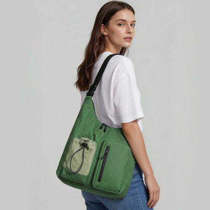 Model wearing a green multi-pocket nylon bag on shoulder.