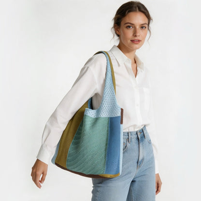 Model carrying the blue, green, and brown crochet shoulder bag, showcasing a relaxed casual style.