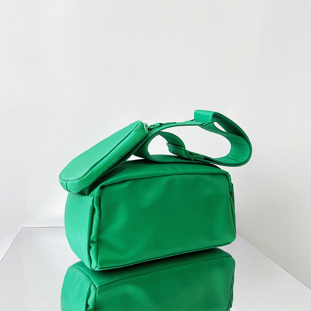 Folded view of Nylon Brick Cassette Crossbody Bag in green, easy for commuting and weekends.