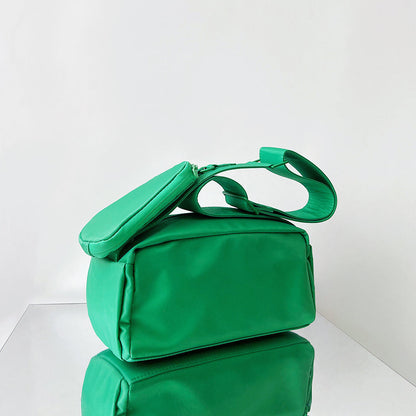 Folded view of Nylon Brick Cassette Crossbody Bag in green, easy for commuting and weekends.
