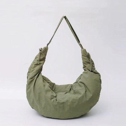 Front view of the olive green puffy crescent bag with a comfortable wide shoulder strap.