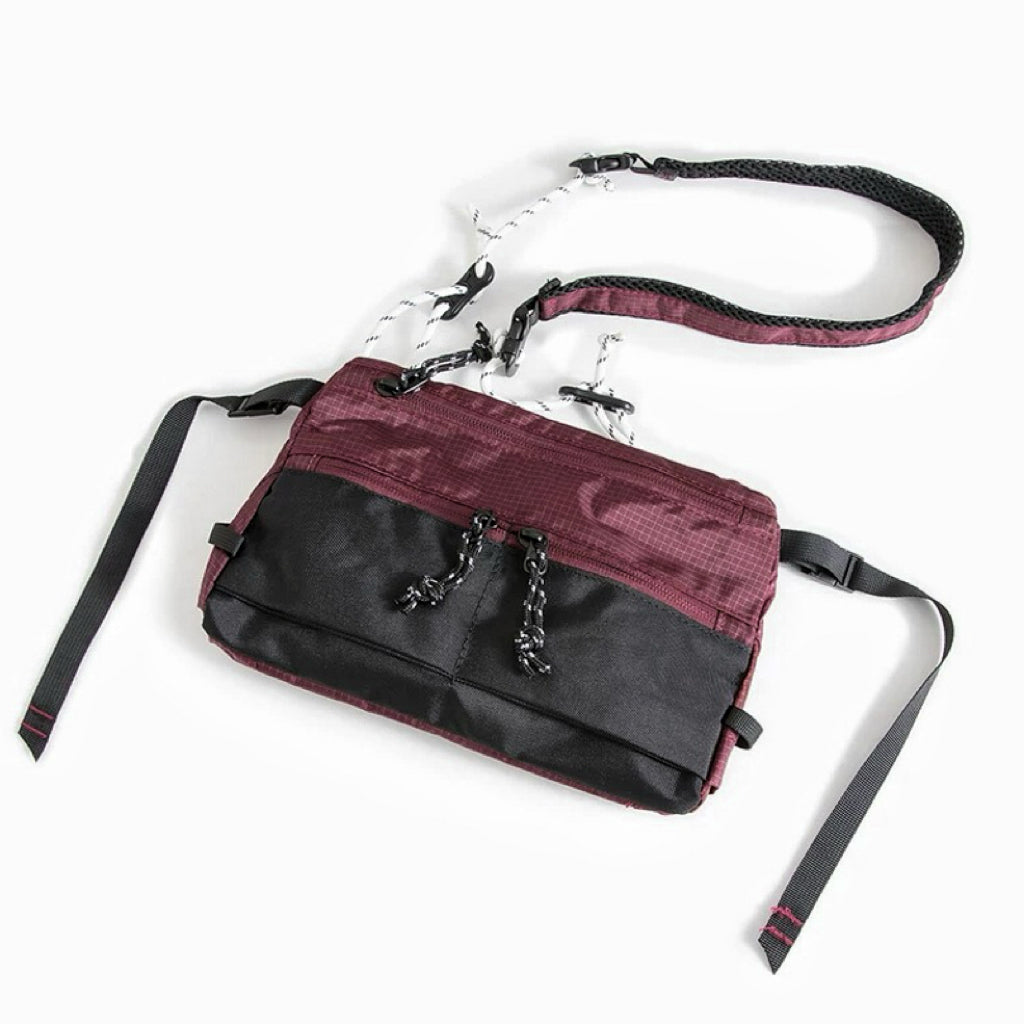 Front view of burgundy outdoor leisure sling bag with adjustable strap, compact travel companion.