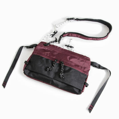 Front view of burgundy outdoor leisure sling bag with adjustable strap, compact travel companion.