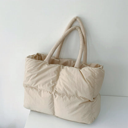 Front view of the apricot padded tote bag showcasing its square quilted texture.