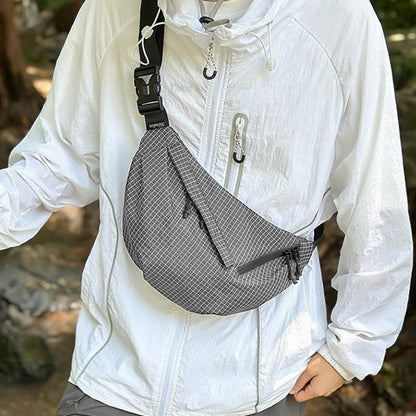 Model carrying a gray plaid nylon sling bag as crossbody, easy for commuting and weekends.