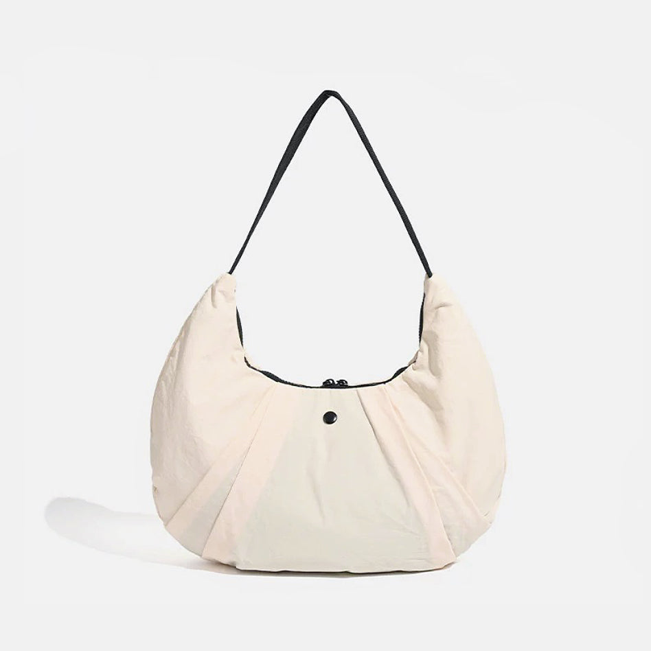 Flat lay of Pleated Crescent Shoulder Bag in beige, ideal for errands and gifting.