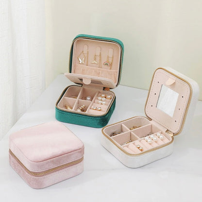 Three colors of Portable Velvet Jewelry Case storage organizer shown together, two open and one close.