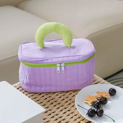Angled view of purple Puffy Candy Makeup Box, great for on-the-go touch-ups.