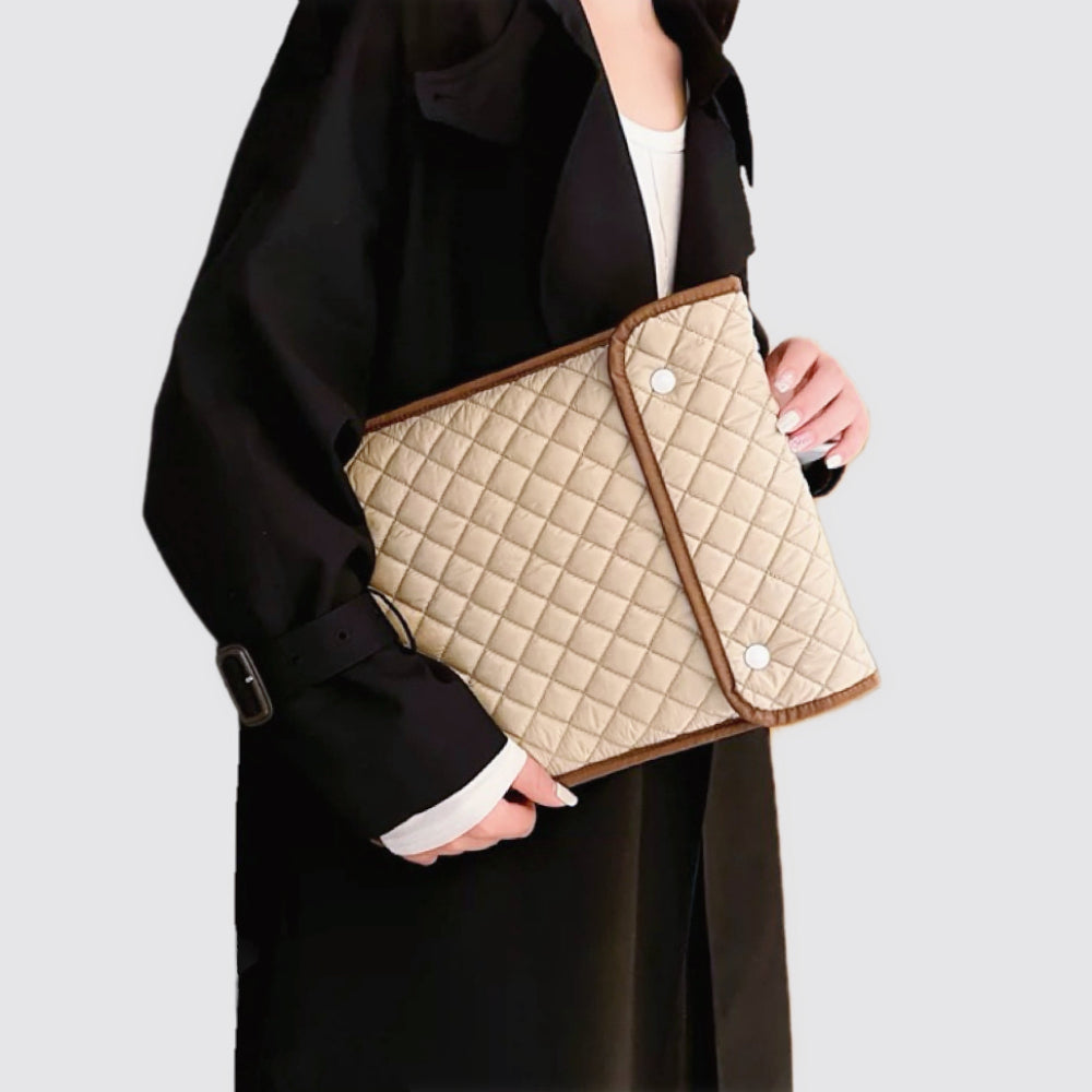 Model carrying a khaki  laptop sleeves handheld, great for daily carry and travel.