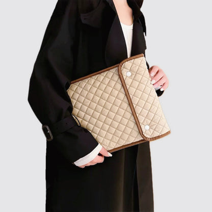 Model carrying a khaki  laptop sleeves handheld, great for daily carry and travel.