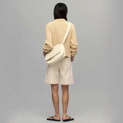 Model carrying a beige polyester bag as crossbody, ideal for city walks and gifting.