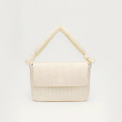 Front view of Puffy Knot Quilted Bag in cream white, great for everyday carry and travel.