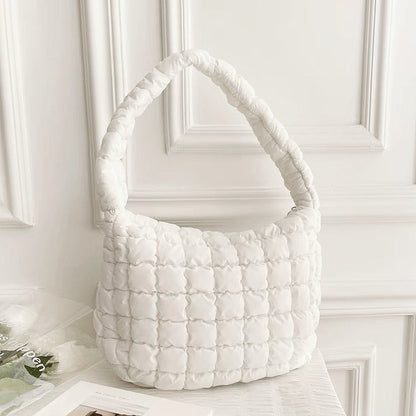 Front view of white puffy shoulder bag on a clean background.