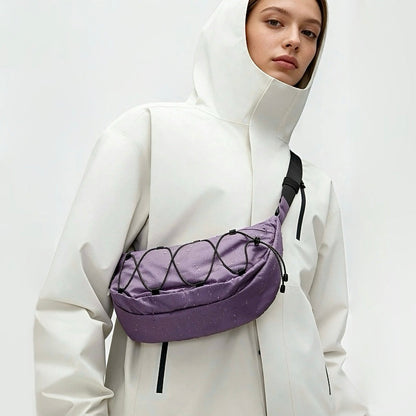 A women wearing a lilac purple  nylon sling bag as crossbody, showcasing sleek crescent silhouette and water-resistant fabric.