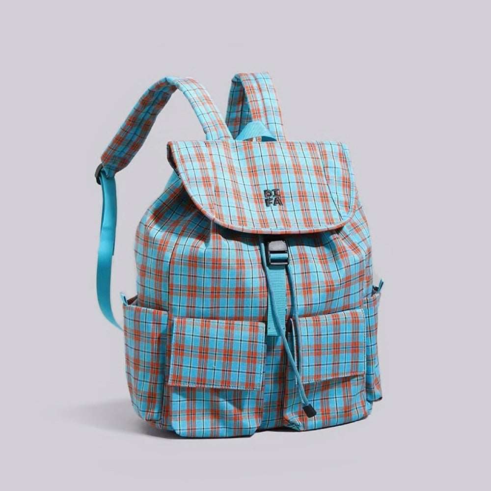 Three-quarter studio view of the blue and orange plaid nylon backpack displaying side pockets.
