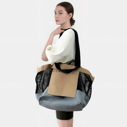 Model wearing the khaki and black double-sided tote bag as a shoulder bag.