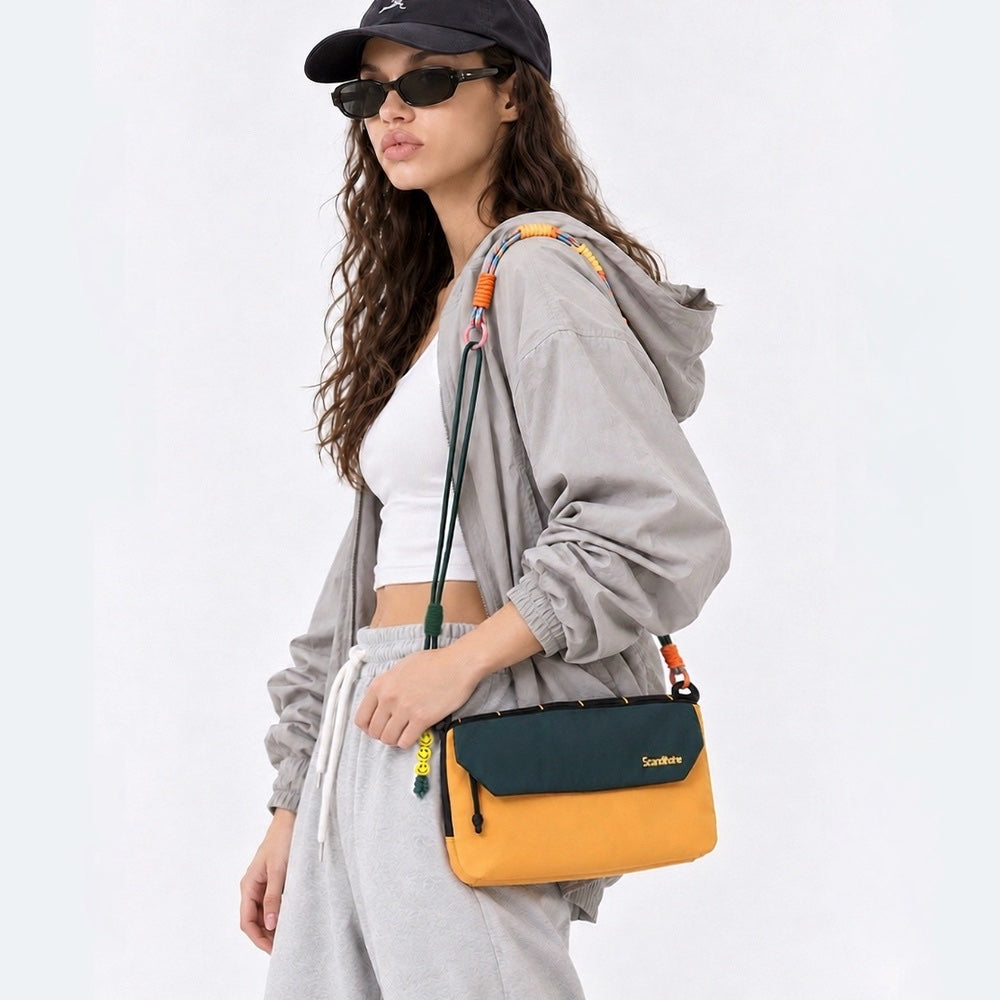 Model wearing the yellow and green Rope Play bag on her shoulder.