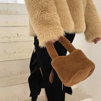 Model carrying a Sherpa Bucket Handbag in brown, great for everyday carry and travel.