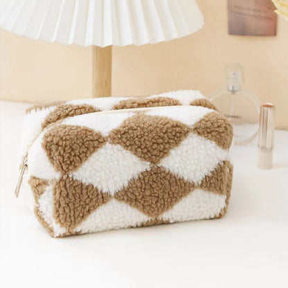 Front view of khaki and white sherpa teddy makeup bag with a diamond pattern and zipper closure.