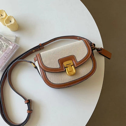 Flat lay of a retro canvas saddle bag with PU leather trim; showcasing the high-quality equestrian style.