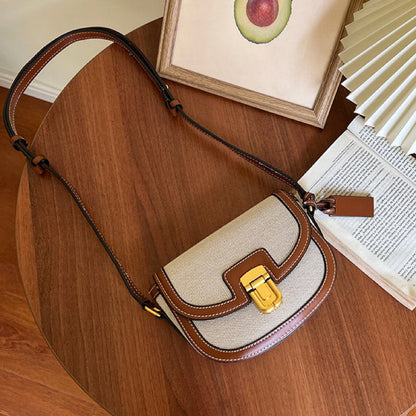Close-up of the vintage saddle bag's pinch-lock hardware and durable canvas texture.