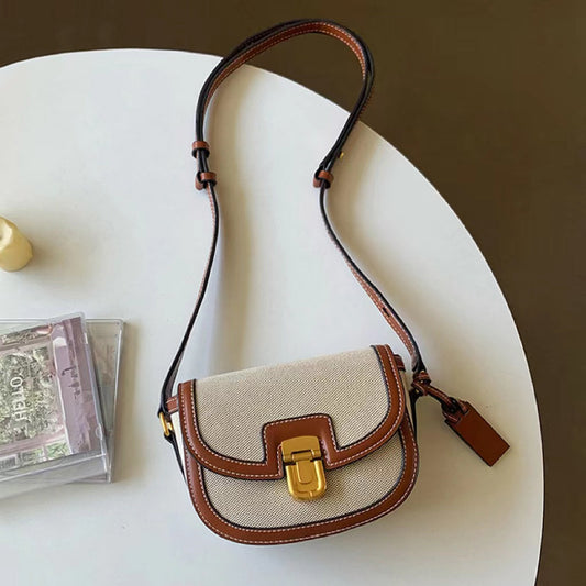 Small vintage saddle bag in brown and cream; best affordable canvas crossbody under $50.