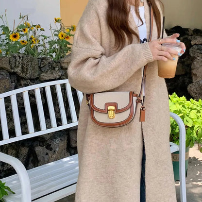 Model wearing a small retro saddle crossbody bag; versatile heritage style accessory for daily fashion.