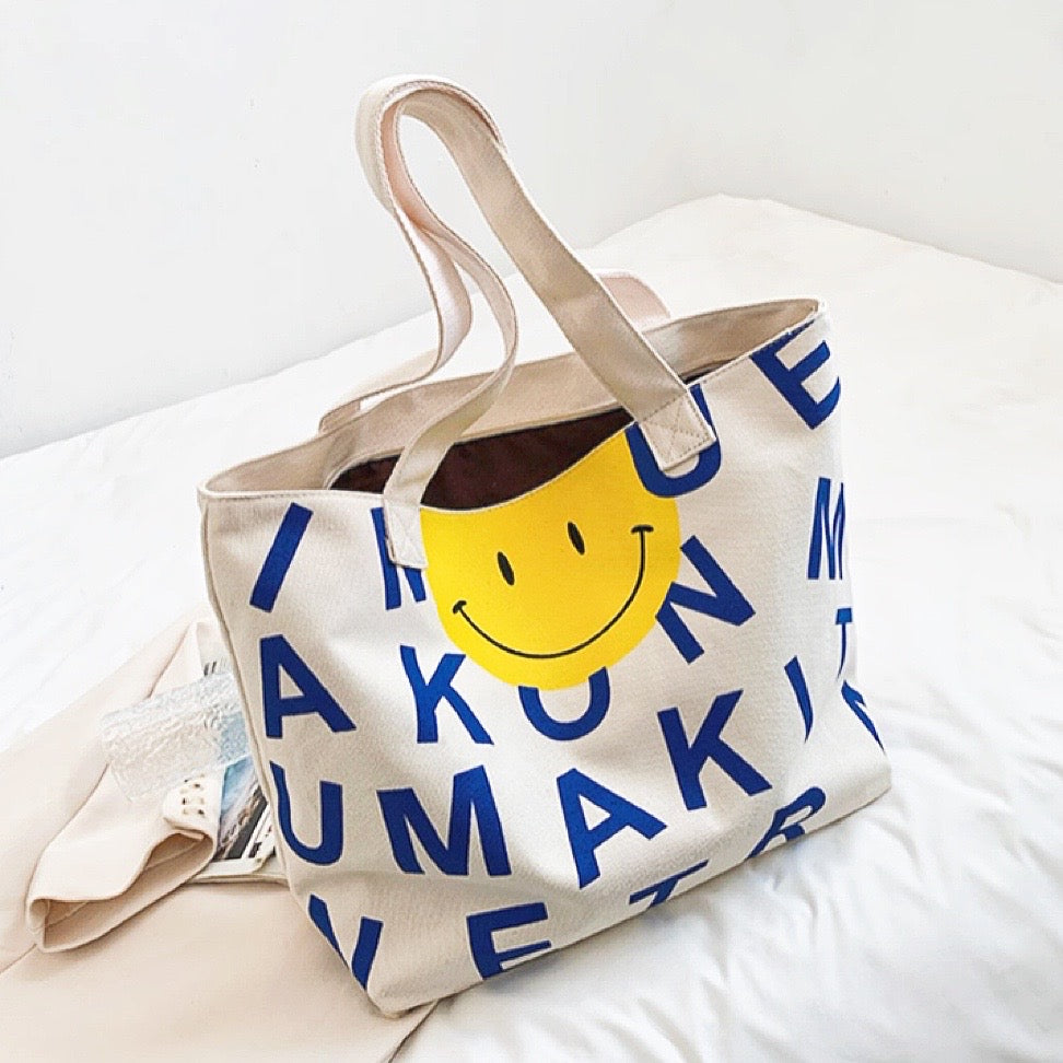 Folded view of Smile Face Canvas Tote Bag in blue, easy for commuting and weekends.