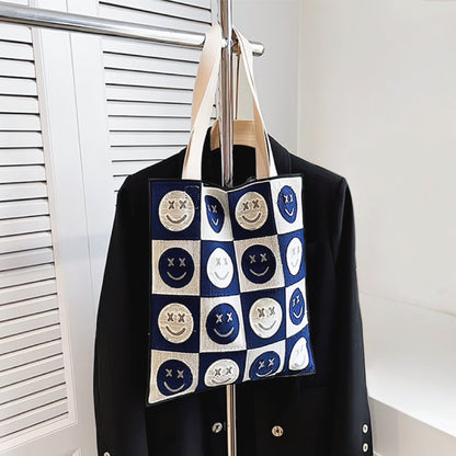 Flat lay of Smiley Plaid Knitted Bag in blue, easy for commuting and weekends.