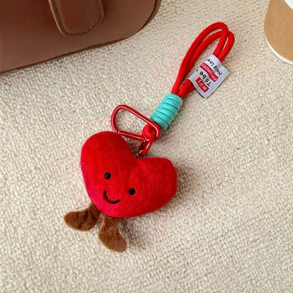 Angled view of Smiling Heart Bag Charm, easy to attach to bags and phones.