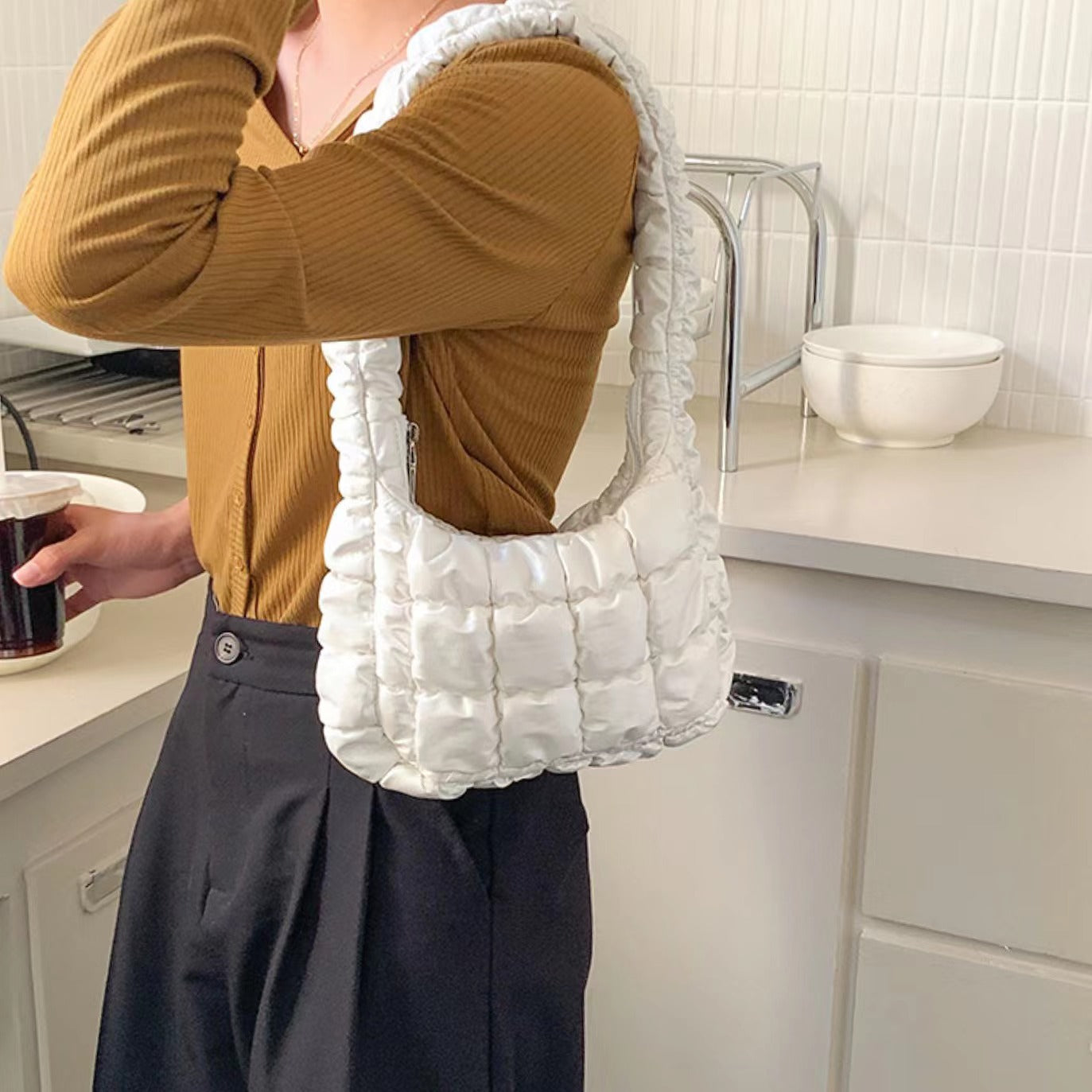 Model carrying a white Soft Leather Puffer Shoulder Bag, easy for commuting and weekends.