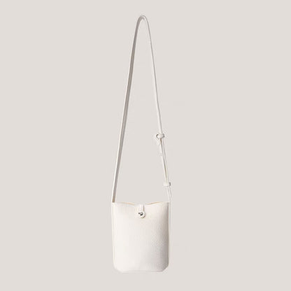 White lychee leather crossbody bag with a metallic designer buckle on clean background.
