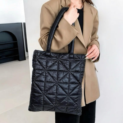Model carrying a black polyester shoulder bag handheld, easy for commuting and weekends.